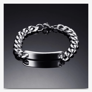 Polished stainless steel Cuban chain bracelet with curved ID plate on dark reflective surface