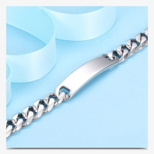 Macro detail of silver stainless steel 11mm Cuban chain bracelet with customizable bar