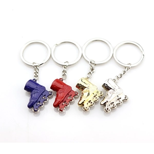 Metal roller skate keychain charms in blue red gold and silver colors with seba logo