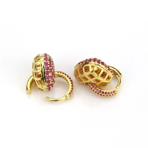 Detailed close-up of gold heart drop earrings featuring pink pavé zircon and mesh backing