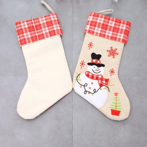 Detailed embroidery of snowman, snowflakes and Christmas tree on premium linen stockings