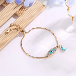 Detailed view of evil eye bracelet with white rhinestones and adjustable gold chain