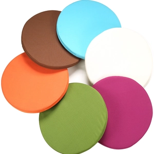 Waterproof round outdoor chair cushions in various vibrant colors stacked on white background