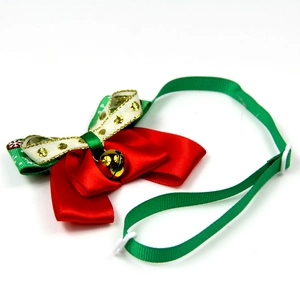 Christmas pet bowtie collar with red and green ribbon and a golden bell on white background