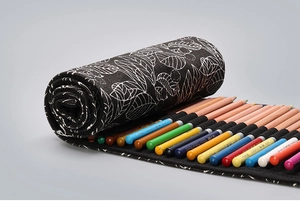 Detail of leaf pattern canvas pencil roll organizer with multiple slots for art supplies