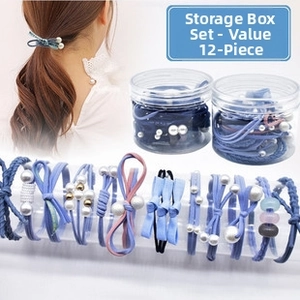 Detail of 12-piece Morandi blue hair tie set with faux pearls and silk bows in clear jars