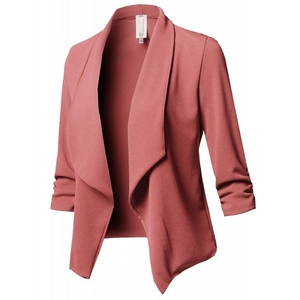 Detail of coral pink blazer featuring 3/4 ruched sleeves and textured crepe fabric