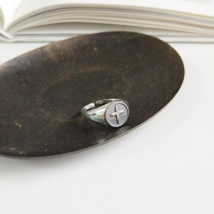 Detail view of the S925 sterling silver stamp on an adjustable cross relief ring