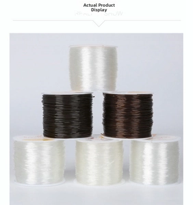 Stack of clear and brown elastic cords on plastic spools for DIY jewelry making