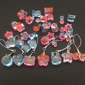Macro detail of gradient resin animal charms and heart pendants for DIY phone lanyards