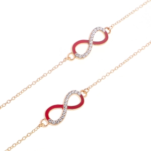 Détail du symbole infini doré avec émail rouge et strass brillants sur la chaîne