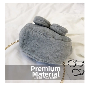 Detail of grey plush faux bunny fur bag with cute ears and golden metal chain strap
