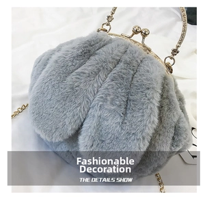 Detail of grey faux fur clutch with gold floral relief handle and metal chain strap