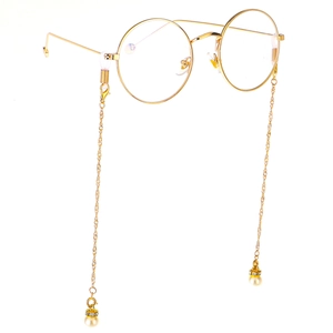 Golden round frame glasses with elegant pearl pendant chain floating on white background