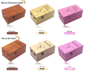 Useless box toy detail showing Merry Christmas and Marry Me themes in various wood colors
