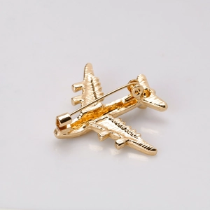 Elegant gold airplane enamel brooch pin in a minimalist metal design for women