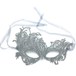 Close-up of silver lace masquerade mask with detailed cutouts and purple silk ribbon