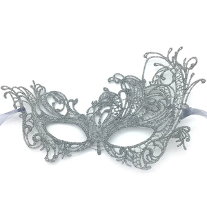 Detailed view of silver glitter lace masquerade mask with intricate cut-outs and ribbon ties