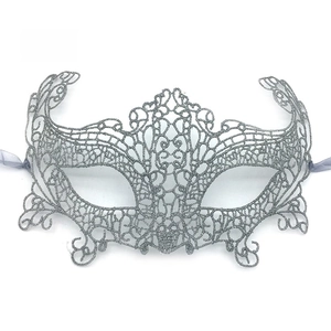 Detailed view of silver lace fox mask with intricate cutout patterns and glitter finish