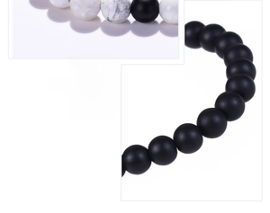 Macro detail of 8mm matte black beads and white marble stones on a beaded bracelet