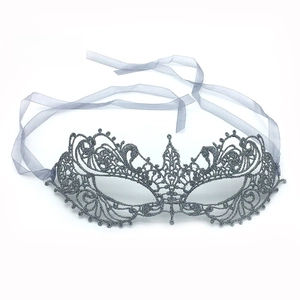 Detailed view of silver lace masquerade mask with glitter finish and pointed tip design