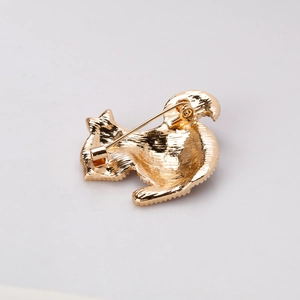 Back view of gold-tone squirrel brooch with metal texture and horizontal pin closure