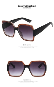 Detail view of large square sunglasses with brown glitter texture and black frame