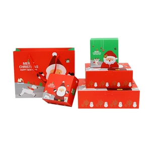 Christmas gift bag and red paper boxes with Santa Claus and reindeer illustrations