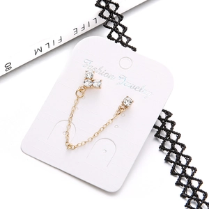 Elegant gold cross chain earring with rhinestone studs on jewelry card display