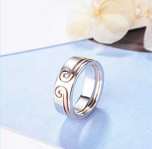 Detail of silver ring with rose gold auspicious cloud pattern and polished finish