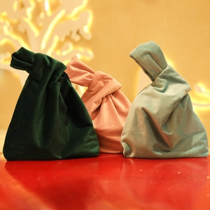 Three premium velvet drawstring bags in green and pink with a knot handle design