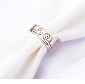 Macro view of hollow cloud pattern on two-tone silver and rose gold metal ring