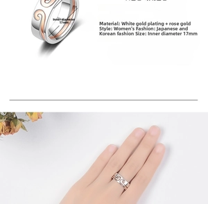 Detail of wave-textured bicolour ring in silver and rose gold finish on woman's finger