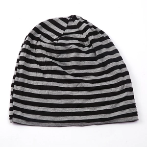 Close-up of black and grey striped knit beanie with soft cotton texture detail
