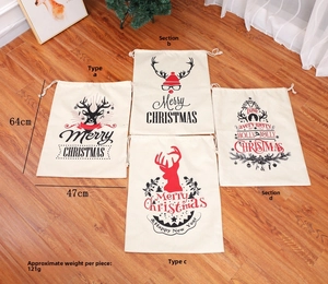 Flat lay of four large burlap Christmas drawstring gift bags with reindeer and tree prints