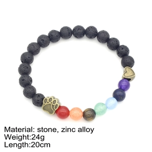 7 Chakra natural stone bracelet with black lava beads, paw and heart charms on white background