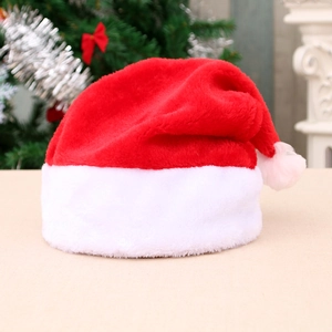 Classic red and white plush Christmas hat for adults and kids on festive background