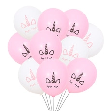 Close-up of pink and white unicorn printed balloons for birthday party decorations