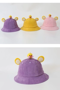 Detail of kids corduroy sun hats with cute chicken decoration and round ears