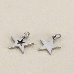 Close-up of polished stainless steel star pendants with hollow out and solid designs