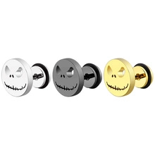 Three-color skull stud earring set in silver, gold, and black finishes on white background