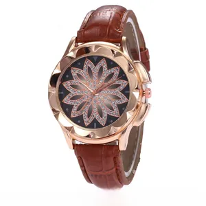 Detail of rose gold case with black floral diamond dial and brown leather strap