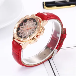 Detailed view of women's watch with rhinestone flower dial and red leather strap