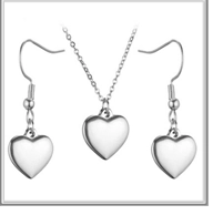 Detailed view of silver heart pendant necklace and matching earrings jewelry set