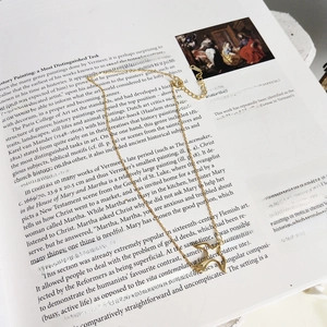Elegant 925 sterling silver bird choker necklace with double pigeon pendant over art book