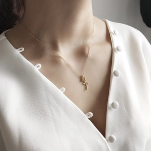 Elegant 925 sterling silver rose gold flower pendant necklace worn by a female model