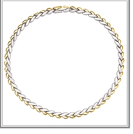 Detail of two-tone braided link chain necklace in polished gold and silver steel finish