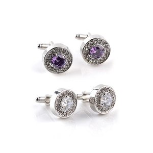 Detail of round silver cufflinks with purple and clear crystals surrounded by small diamonds