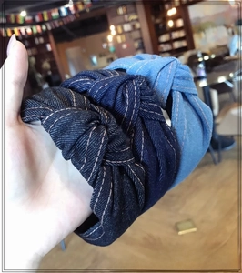 Close-up of denim knotted headbands showing three blue shades with contrast stitching
