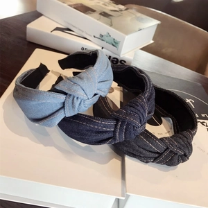 Three pieces of denim knotted headbands in light blue, dark blue, and black colors